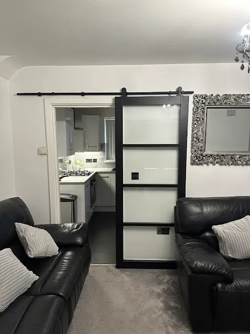 Black sliding barn door with glass panels