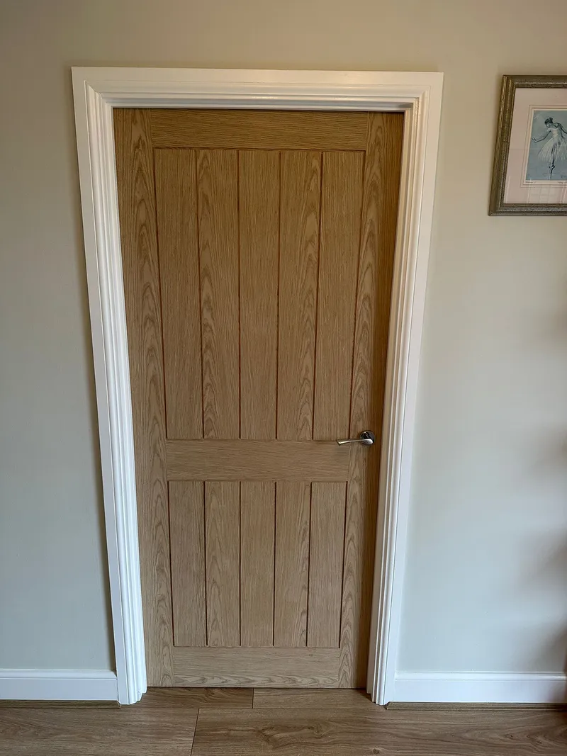 Oak panel internal door with chrome handle and white frame