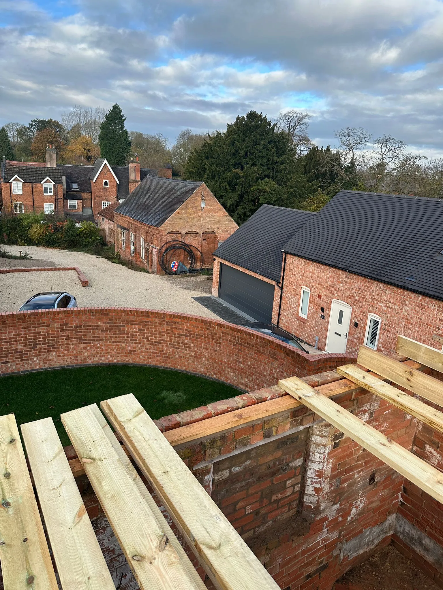 Curved brick wall with timber joist framework