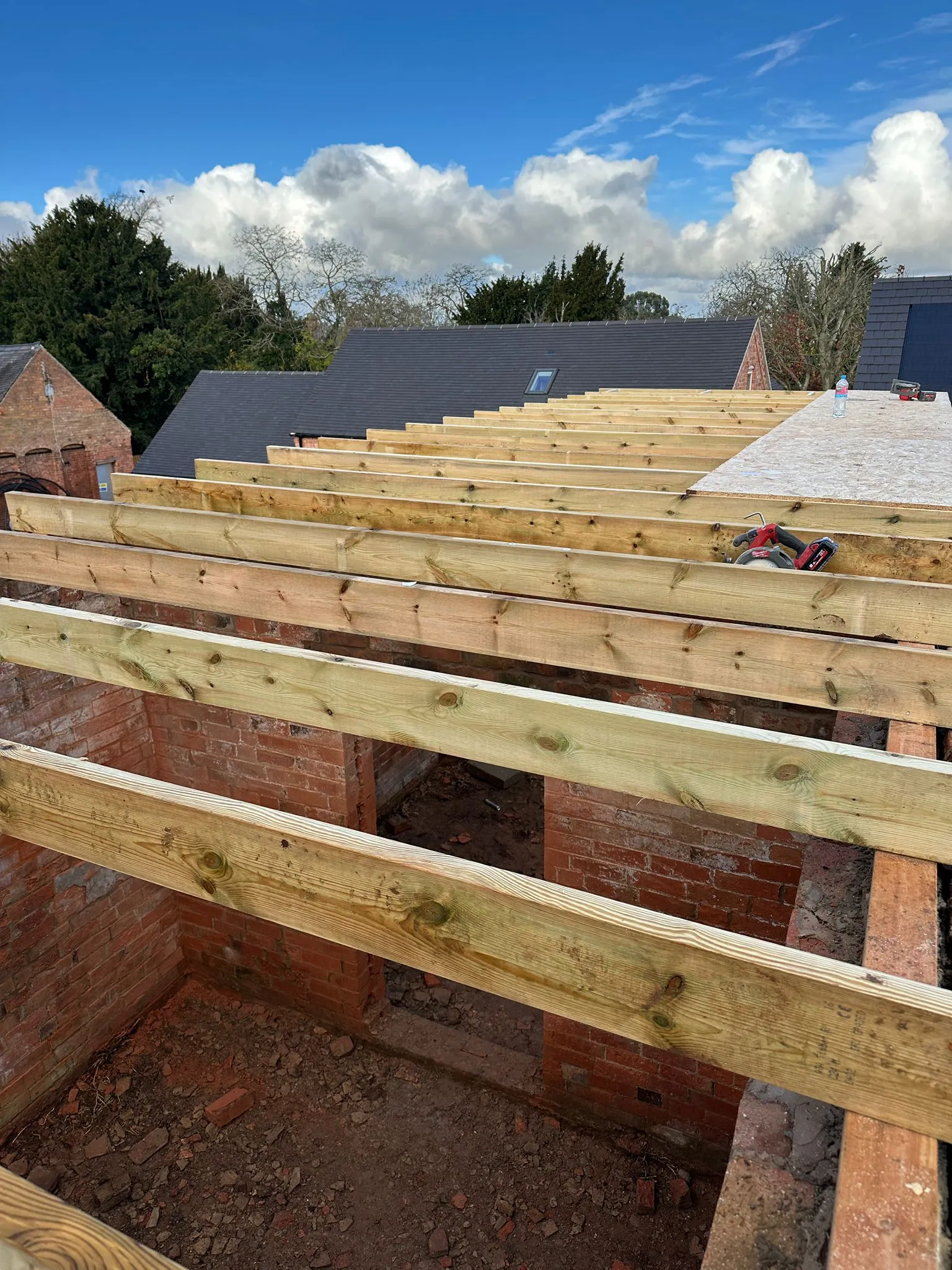 Roof joist installation close-up on brick walls