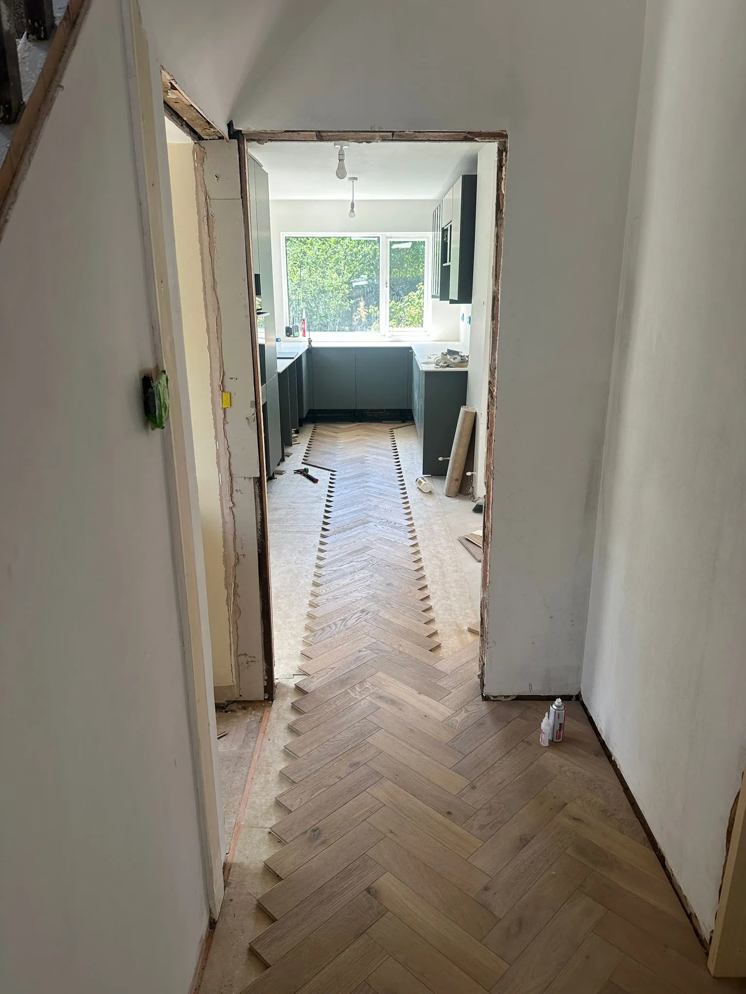 Herringbone flooring being laid through to kitchen