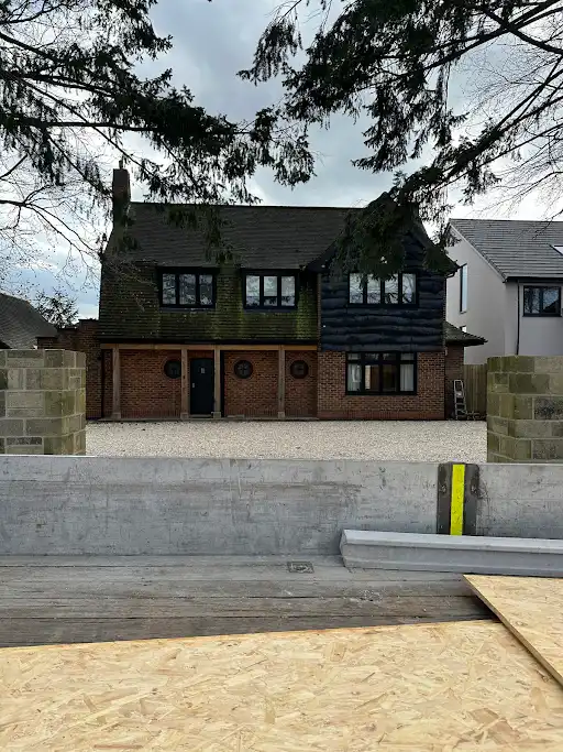 Brick house exterior with new-build construction