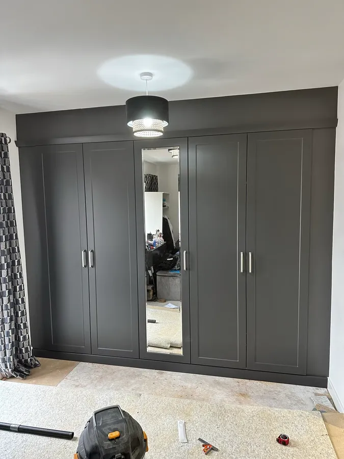 Fitted dark grey wardrobes with mirror panel